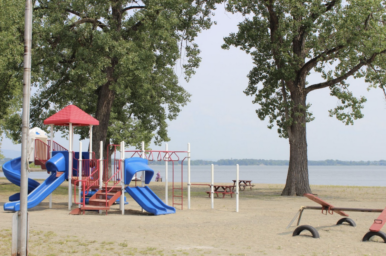 Playground equipment on a sandy beach.